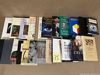 Books arranged standing and stacked, showing a variety of titles and colorful covers related to philosophical, scientific, and spiritual topics