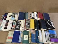 Overview of 35 books arranged in multiple rows showing a variety of book covers, colors, and sizes.