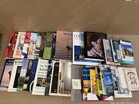 Several rows of assorted books from the lot showing variety of topics and titles, mostly reference and non-fiction with some art and gardening focus.