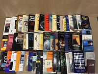Photo showing front row and back row of books arranged on a surface, featuring a wide range of academic and intellectual topics.