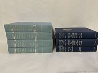 Photo showing 4 volumes of George Washington by James Thomas Flexner in light blue hardcover and 3 volumes of Jefferson and His Time by Dumas Malone in dark blue hardcover.