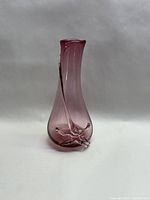 Front and side views of the pink glass flower vase showing swirl design and clear glass decoration on base