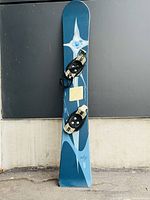 Full length top side view of the blue Burton ALP 69 snowboard with binding mounts.