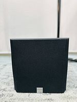 Front view of the Creative Inspire 6.1 6700 medium size speaker showing fabric grille with logo.