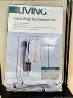 Box showing product name and features including steel frame with chrome finish, holds 30 lb, height adjustable, collapsible design.