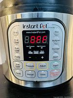 Close-up of Instant Pot control panel showing buttons and digital display with 'OFF' on screen.
