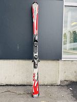 Front view of one Rossignol ski showing the upper surface with model name 100 and attached binding.