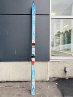 Full-length view of one blue Racing M46 ski with visible design and binding mount.