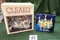 Photo showing original packaging boxes for the 24% lead crystal creamer set and Royal Korona Bellis candle holder.