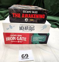 Three stacked game boxes: Escape Tales The Awakening on top, Nefarious in the middle, Escape from Iron Gate bottom. Label with number 69 in front.