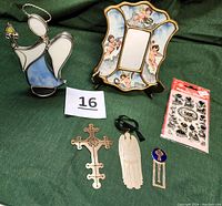 Full lot arranged showing six items: stained-glass angel candleholder, hand-painted cherub mirror, package of angel Christmas labels, brass cross, metal angel ornament, gold-plated Celtic cross bookmark.