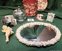 Full lot including glass jar with floral lid, vintage rose mirror tray, porcelain frame, cherub and angel figurines, and packaging box
