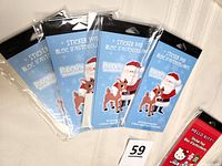 Four packages of sticker pads featuring Rudolf and Santa, new and unopened