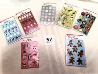 Overview photo showing all six unopened sticker packages arranged on a light wood surface, displaying the variety of designs included in the lot.