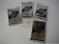 Four sealed Upper Deck hockey card packs from 1992-93 series, silver foil with black print, laid on a white background.