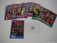 Front view of 14 Marvel Super Heroes trading cards from 1992 laid out in fanned stacks showing character artwork including Cable, Juggernaut, Sunspot, Imperial Guard.