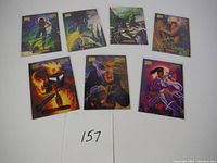 Seven Marvel Masterpieces trading cards laid out on white background with handwritten lot number '157'. Shows full set of cards in a single photo to display contents.