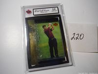 Front of 2001 Upper Deck Golf #T28 Tiger Woods rookie card in graded slab showing player image and foil signature