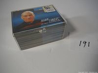 Stack of the complete 1992 Star Trek TNG trading card set in clear plastic box with label.