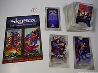 All cards spread including bonus promo card sheet with two embossed foil Superman cards and the rest of the standard cards stacked.