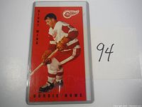 Front view of the Gordie Howe hockey card in protective sleeve, showing player in red and white uniform.