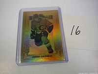 First Johnny Gaudreau Gold Etchings card, front view with player image and gold foil design, inside plastic sleeve