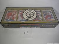 Front view of the complete factory sealed set packaging with visible hockey card designs inside. Set has an Ontario Hockey League official factory seal with set number sticker.