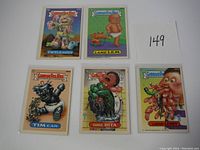 All five Garbage Pail Kids cards displayed on white background, front view showing artwork and titles.