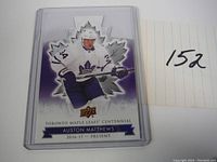 Front view of Auston Matthews die-cut hockey card in protective case showing player image and team branding.