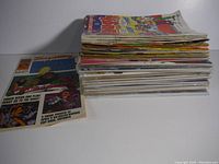 Stack of assorted comic books showing varied titles and issues