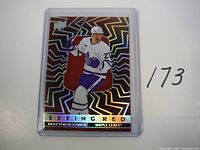 Front side of the Matthew Knies Seeing Red rookie hockey card showing holographic foil design, player image, and embedded red jersey patch.