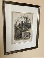 Framed colored engraving hanging on a wall, showing a view of the University of Toronto with a smaller inset image of the main porch.