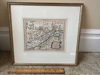 Framed map displayed with ruler for scale.