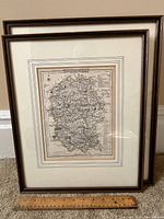 Two framed maps of Wiltshire, England with a wooden ruler for scale showing lot contents