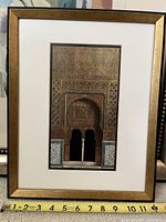 Frontal view of framed art print showing ornate archway detail and gold frame with measuring tape at bottom indicating approx 12 inch width
