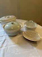 Four different casserole dishes, showing white ceramic, Corningware and Pyrex glass lids