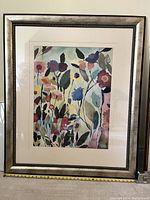 Full view of large framed painting featuring an abstract floral garden with multiple colored flowers and leaves, including a blue tulip in the center area.