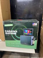 Front of sealed box showing MASINGO Karaoke Machine Alto X6 branding