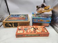 Photo of all board games in the lot showing Space Till, Secret Hitler, Exploding Kittens Harry Potter, Hot Tub High Dive, Loaded Questions Junior