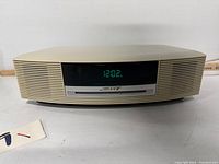 Front view of Bose Wave Music System powered on showing digital display and CD slot