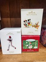 Three boxed Hallmark Keepsake Christmas ornaments - Disney Sleigh Ride, Ryan Howard baseball player, Max the Snowman