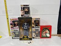 Full lot with six Funko Pop figures and a boxed Santa collectible arranged for measurement comparison