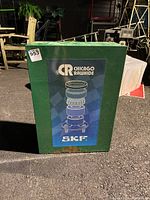 Front view of a green metal parts cabinet with Chicago Rawhide SKF label and slight rust.