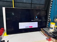 Front view of LG 55 inch TV powered on showing 'No Signal' message on screen.