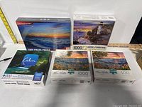 Five new boxed puzzles of various piece counts and scenic themes.