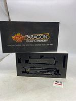 Original black box lid and foam insert showing Paragon Rolling Thunder branding and lot contents (locomotive and tender).