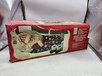 Original packaging of Sleeping Santa Motionette showing product and text describing features.