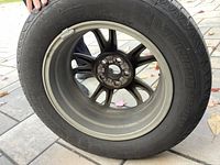 Side view of tire and rim showing Michelin brand and tire size 195/65R15.