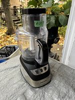 Black & Decker food processor showing the front with control buttons, clear bowl, and handle.