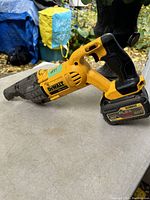 Side view of the DEWALT sawzall on a table, showing the overall condition and design.